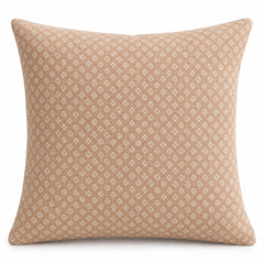 Peach square cushion cover with repeating small cream geometric textured-style pattern