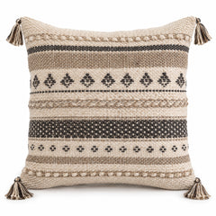 Natural ivory cushion cover with black tribal stripes, geometric motifs and corner tassels