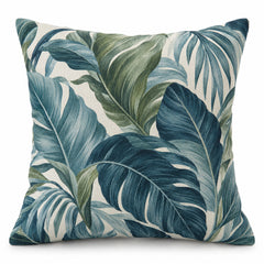 Teal square cushion cover with layered tropical botanical leaves in green and blue tones