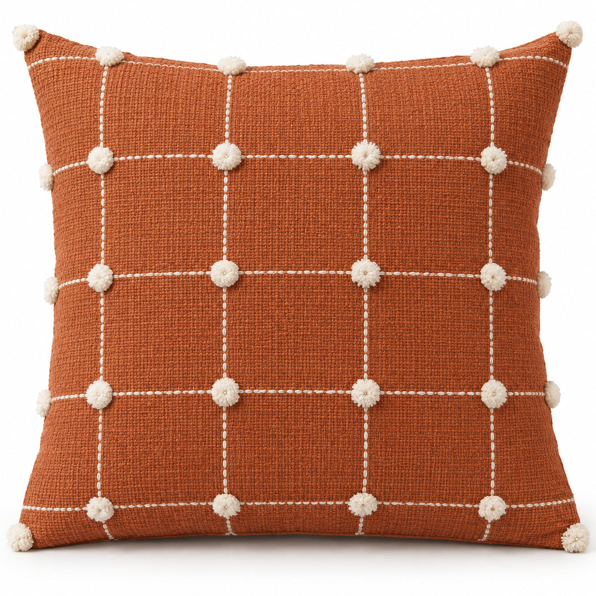 Rust orange square cushion cover with white grid lines and pom-pom details at the grid intersections