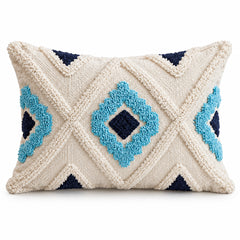 Ivory square cushion with raised looking turquoise and navy blue geometric diamond motifs