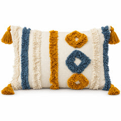 Ivory rectangular lumbar cushion with navy blue and mustard textured looking tribal accents and corner tassels