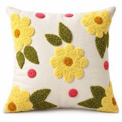 Cream square cushion with bright yellow flower motifs green leaves and raised looking floral texture