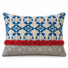 Blue and ivory square cushion with repeating ornamental geometric motifs and contrasting rust red lower border