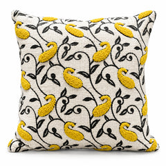 Ivory square cushion with yellow birds dark branching vines and small botanical flowers