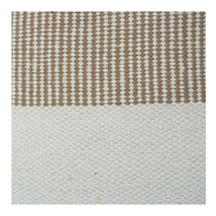 Textured rug with a striped pattern in brown and white on a light gray background