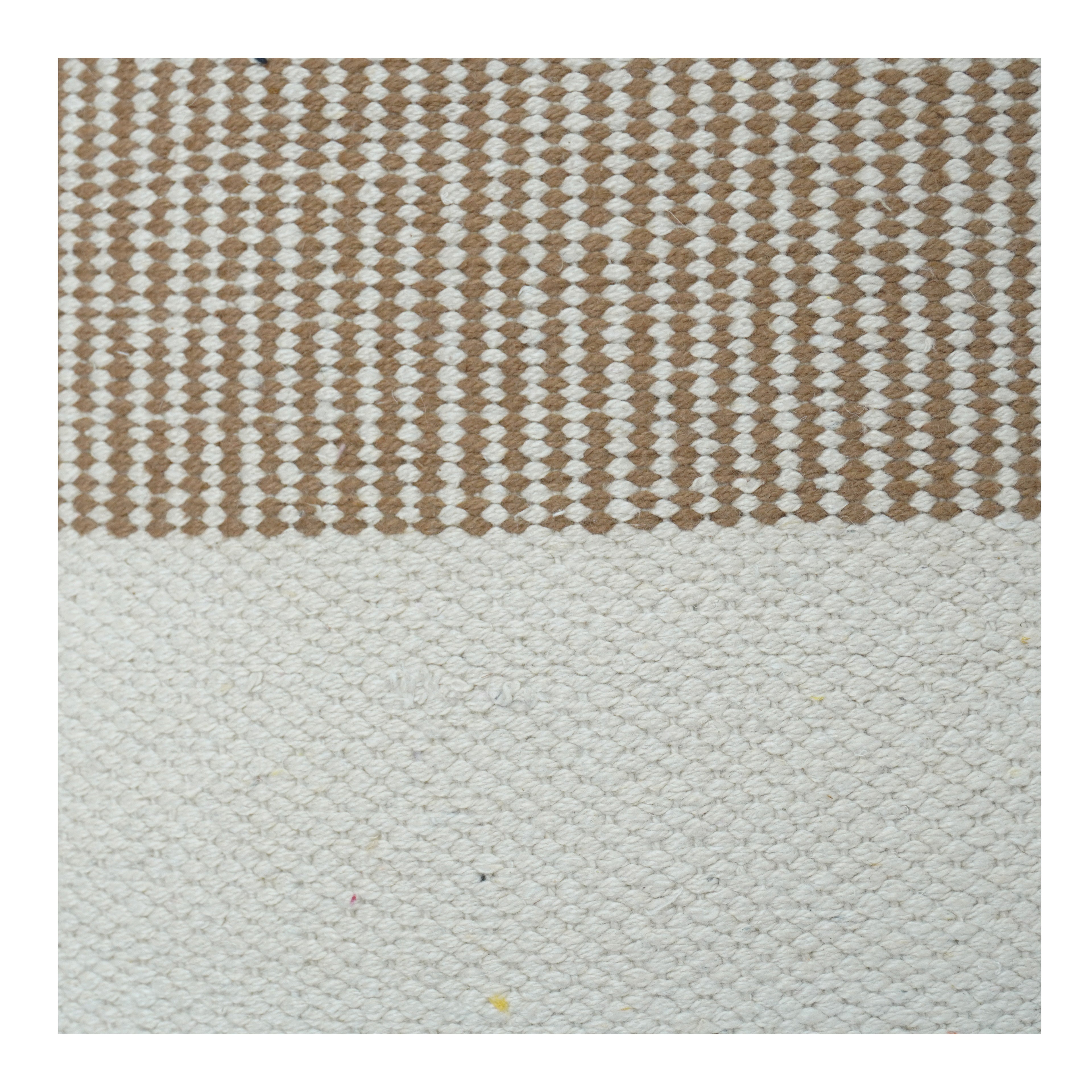 Textured rug with a striped pattern in brown and white on a light gray background