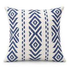 Ivory square cushion with bold indigo blue tribal diamond motifs arranged in vertical bands