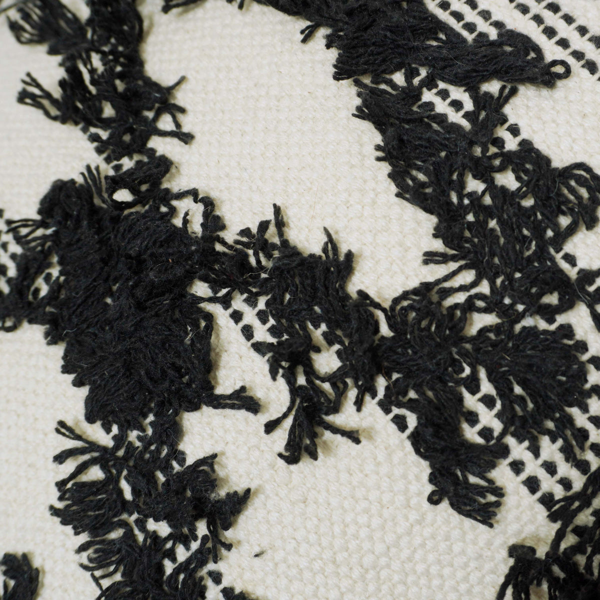 Black and cream geometric textured handwoven cushion cover with tassels 45x45 cm