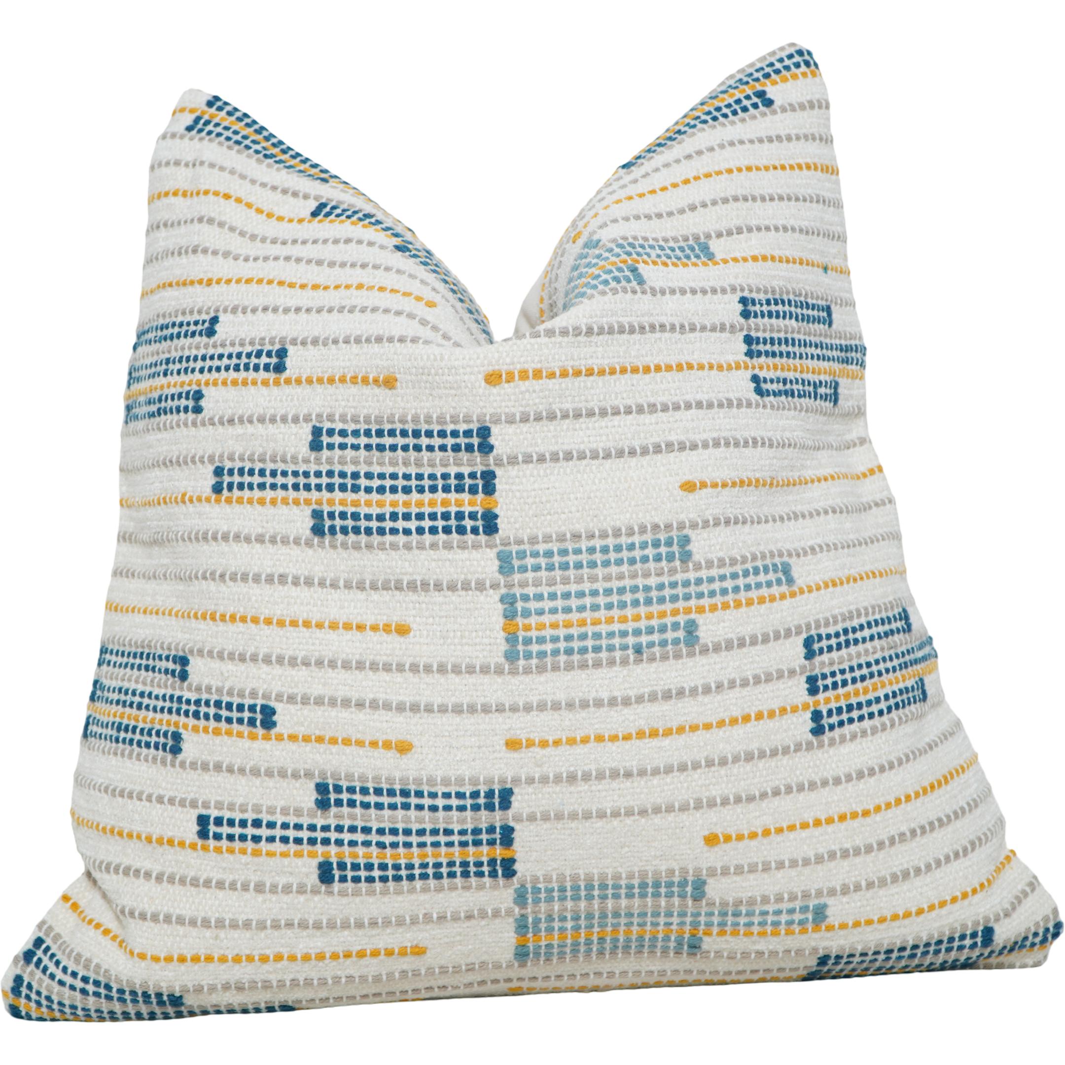 Decorative pillow with blue and yellow pattern on a white background