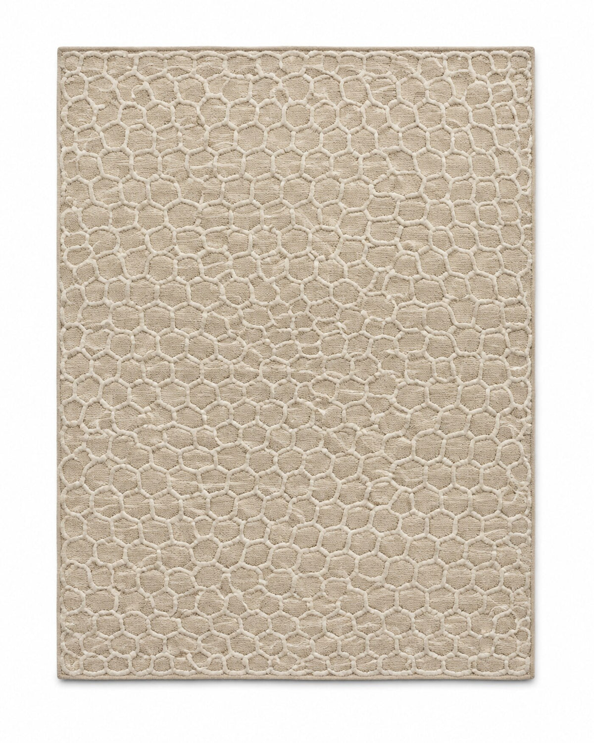 Beige textured area rug with small honeycomb-inspired surface pattern and tonal depth