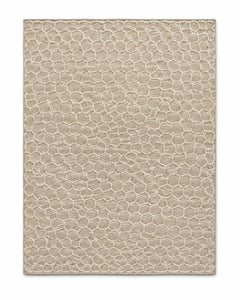 Beige textured area rug with small honeycomb-inspired surface pattern and tonal depth