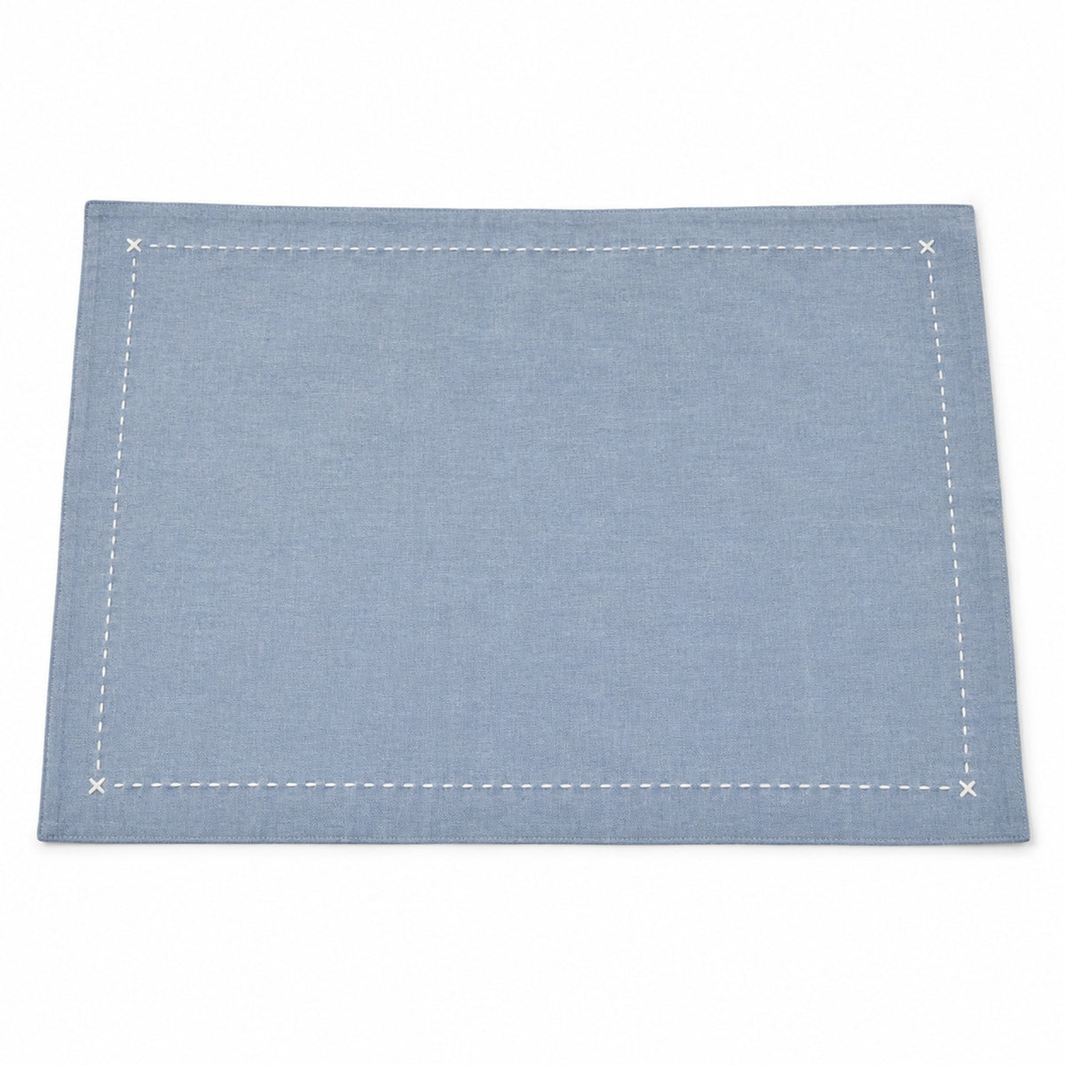 Dusty blue solid placemat with white contrast stitched border and corner cross details by Primeval