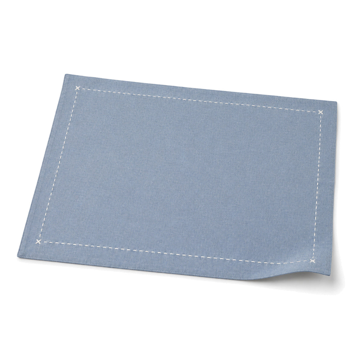 Dusty blue contrast-stitch placemat shown in a premium angled presentation, lightweight table linen by Primeval
