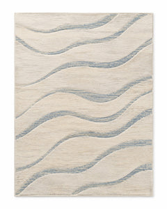 Ivory area rug with soft blue flowing wave stripes and airy coastal-inspired look