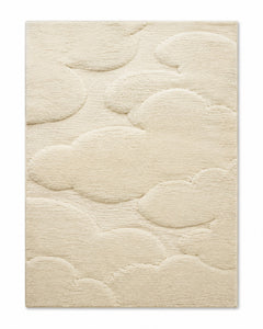 Ivory area rug with raised cloud and pebble shapes for a soft sculptural cozy look