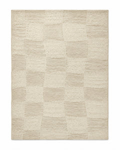 Ivory and beige checkerboard area rug with soft tonal blocks and textured surface