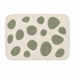 Ivory rounded placemat with sage green organic pebble motifs, contemporary textured dining table mat by Primeval