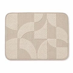 Ivory and taupe rounded placemat with abstract arc patchwork geometry, contemporary textured dining table mat by Primeval