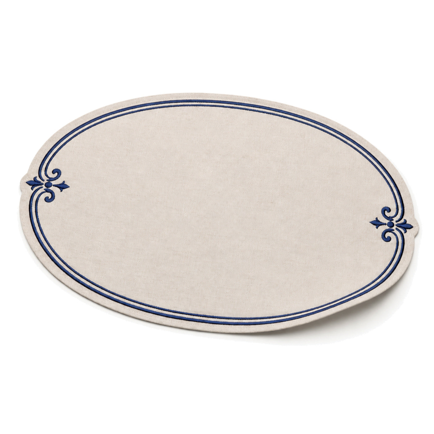 Oval ivory and navy ornamental-border placemat shown in a premium angled presentation, elegant table linen by Primeval
