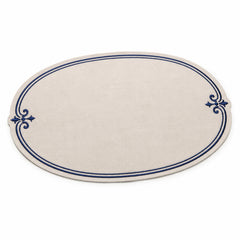 Oval ivory placemat with navy double border and ornamental side flourishes, elegant dining table mat by Primeval