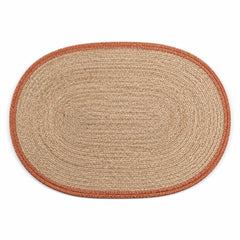 Oval natural woven placemat with rust terracotta contrast border, warm table mat by Primeval