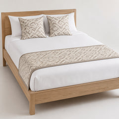 Beige botanical-texture bed runner styled on white bedding for wholesale resort, hotel and home textile sourcing