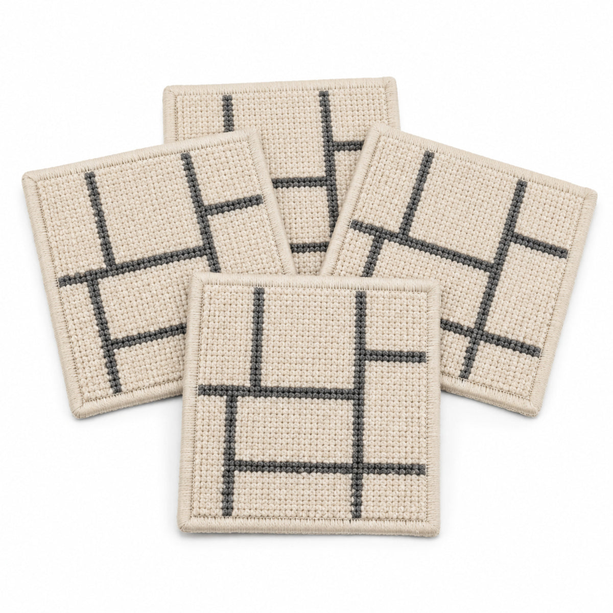 Beige charcoal linear geometric coaster set on a clean white background
