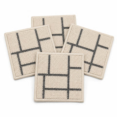 Beige charcoal linear geometric coaster set on a clean white background