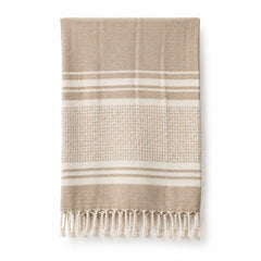 Beige and cream striped fringed cotton hammam towel 90x180 cm on white background