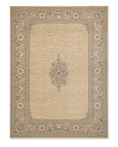 Beige and muted blue hand-knotted area rug with an ornate floral border and small central medallion on a white background.