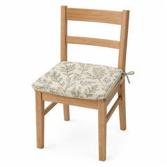 Primeval beige and sage botanical leaf dining chair pad with tie straps on wooden dining chair