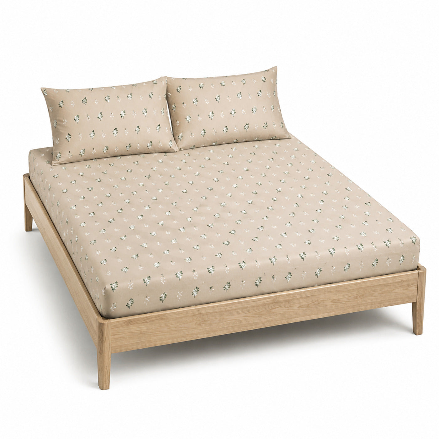 Beige and sage small botanical bed sheet set with matching pillowcases on a wooden bed