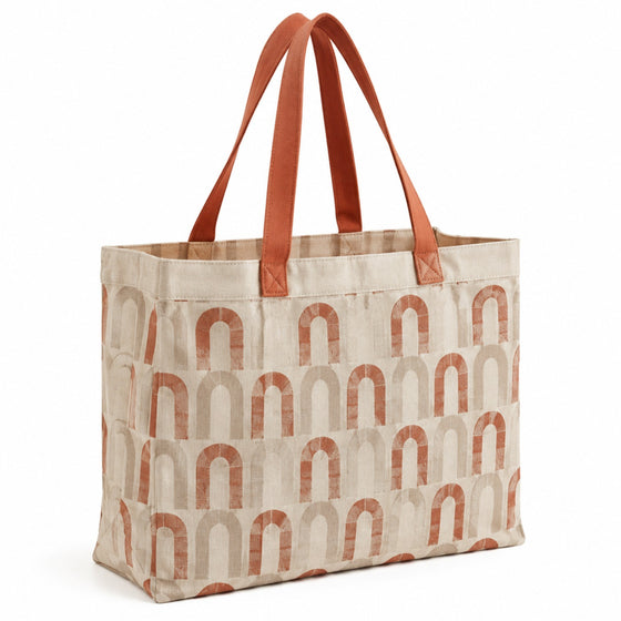 Beige tote bag with terracotta arch print and terracotta handles on a white background.
