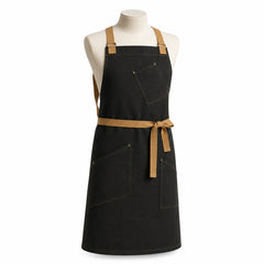 Primeval black chef apron with camel straps and contrast utility pockets displayed on a dress form