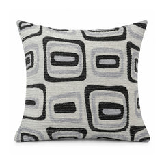 Primeval black and cream cushion with repeated outlined rounded rectangles and retro geometric squares