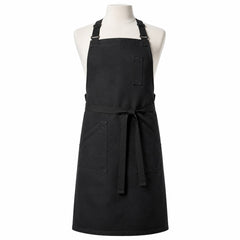 Primeval black cross-back chef apron with utility pockets displayed on a dress form