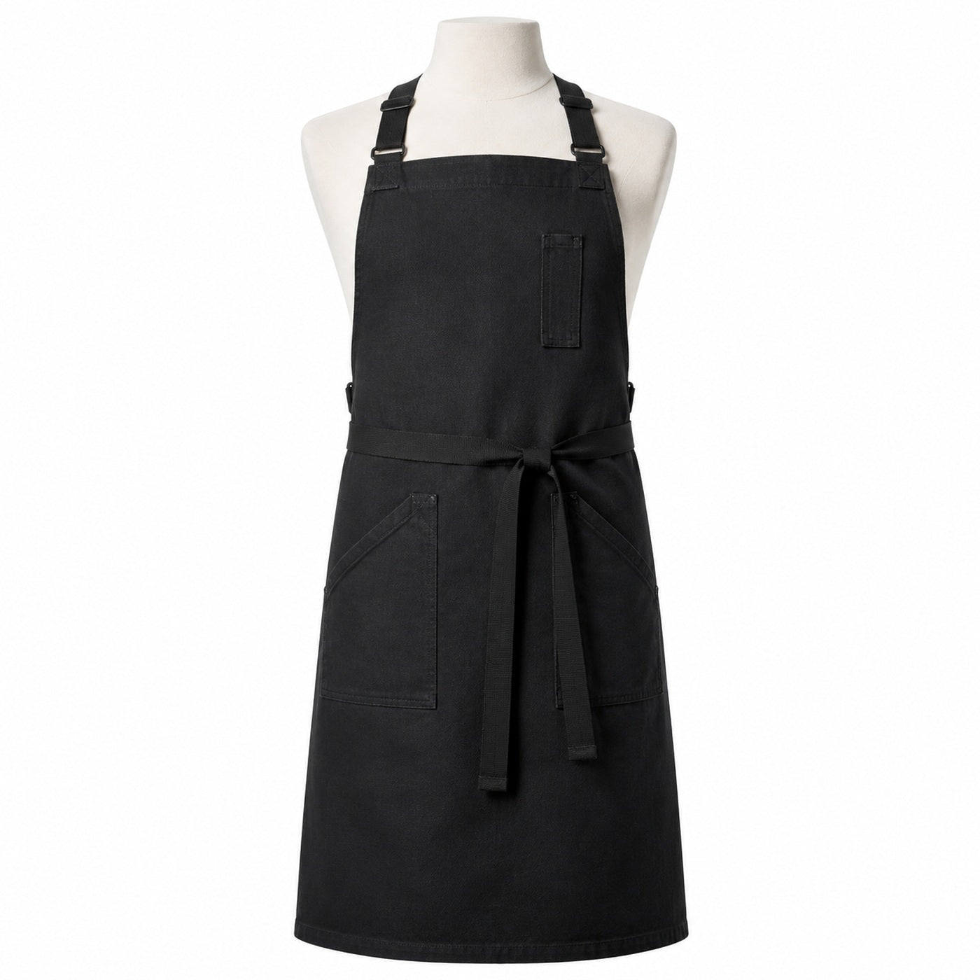 Primeval black cross-back chef apron with utility pockets displayed on a dress form