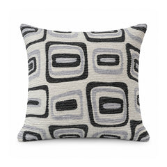 Primeval black and ivory cushion cover featuring rounded squares and rectangular abstract geometric shapes