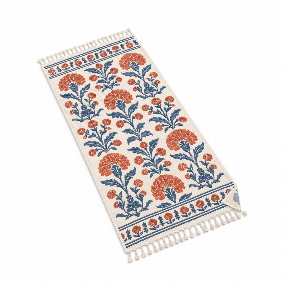 Ivory fringed beach towel with blue and terracotta botanical floral print.