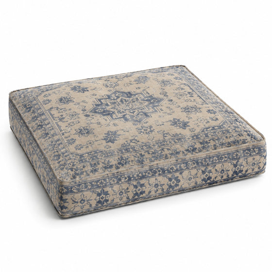 Beige square floor cushion with blue vintage floral pattern on white background