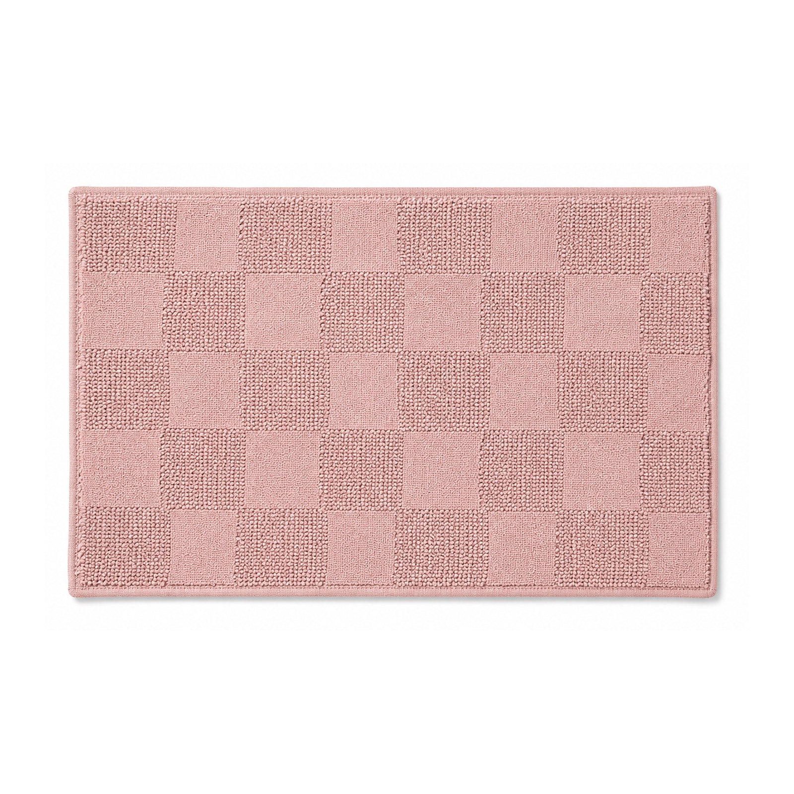Blush pink checkerboard textured cotton bath mat on white background