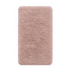 Blush pink plush high-pile shag cotton bath mat on white background