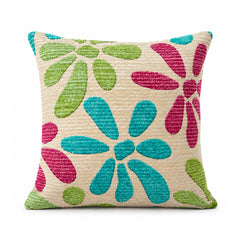 Primeval ivory cushion decorated with oversized teal blue magenta and lime green graphic floral petals