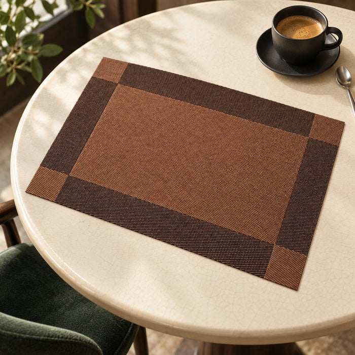 Cocoa brown rectangular placemat with dark espresso border and darker corner blocks on a cream-coloured round table