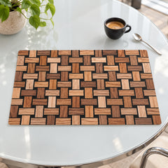 Rectangular brown and honey wood-block-look placemat with interlocking basket grid squares displayed on a glossy pale tabletop
