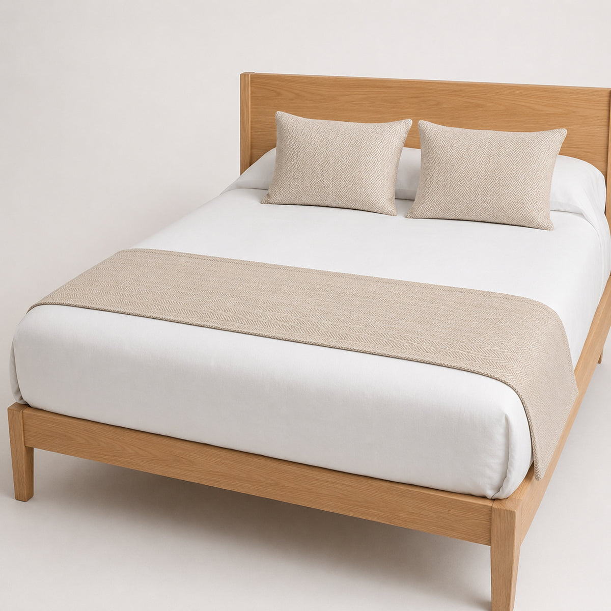 Champagne beige woven bed runner styled on crisp white bedding for wholesale hotel and private-label bedroom collections