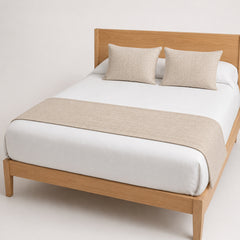 Champagne beige woven bed runner styled on crisp white bedding for wholesale hotel and private-label bedroom collections