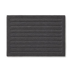 Charcoal grey ribbed bath rug with horizontal stripes on white background
