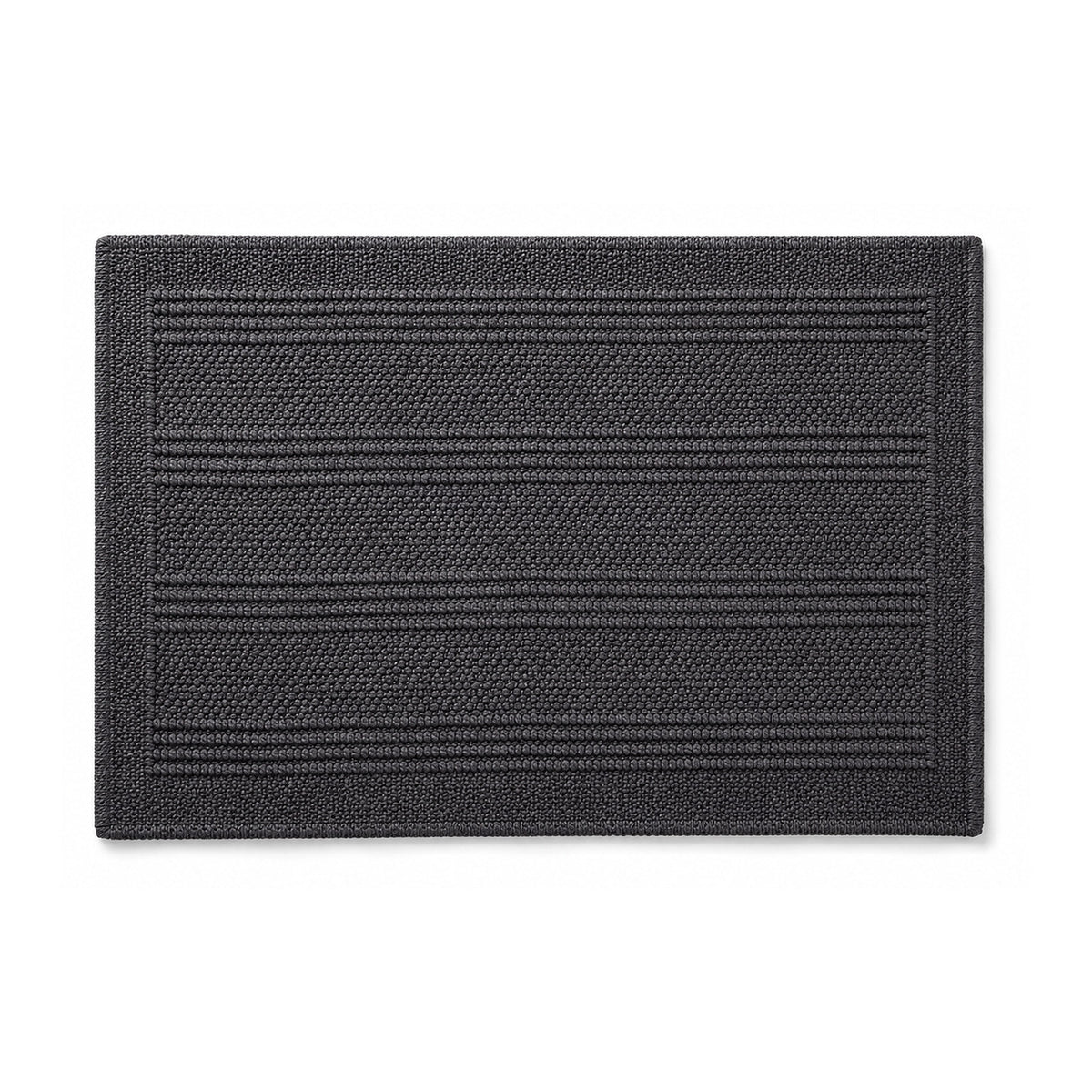 Charcoal woven bath mat with linear texture on white background
